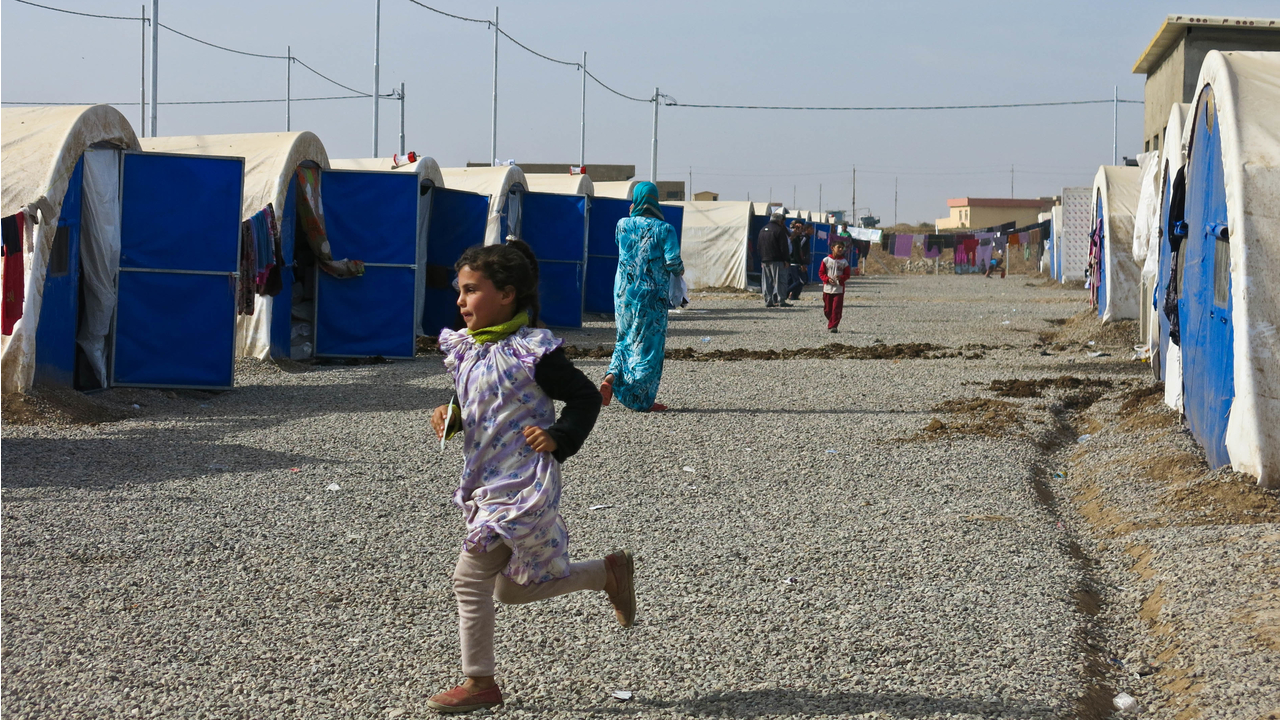 A girl from a displaced family plays in Khazer camp.  