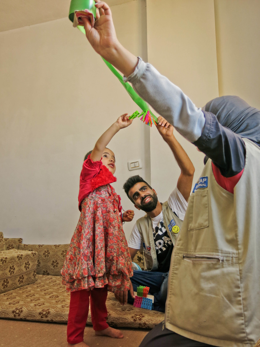 Huda reaches for objects during a rehabiliation session