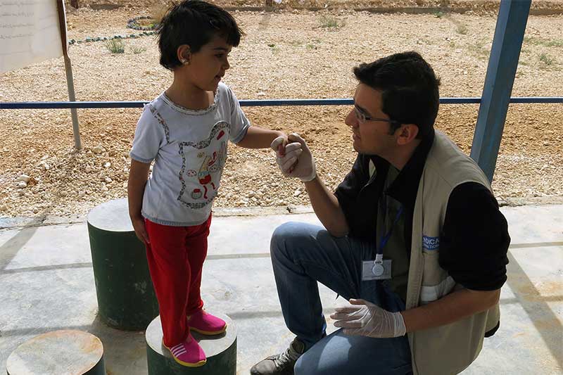 Malak having a rehabilitation session with a Handicap International physical therapist, in Jordan.