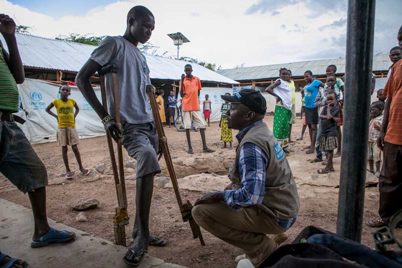 Handicap International rehabilitation team leader speaks with Simon at Kakuma camp reception center