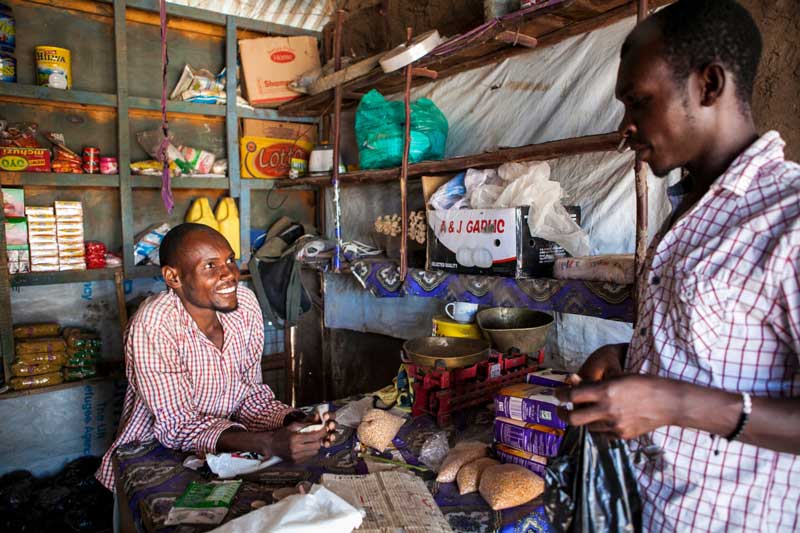 Noor with a customer in his shop.