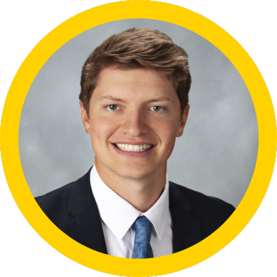A white man with blond hair wearing a suit and tie