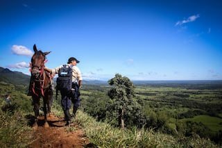 Marta on a mountain trail, next to a horse