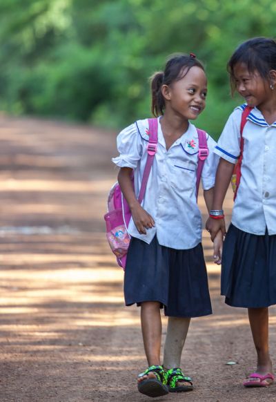 Channa, 7 years old, with a classmate on the way to school