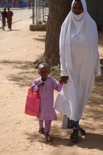 Mahamadou going to school with his grandmother, Zeinab Hajiya. © J. Labeur / HI