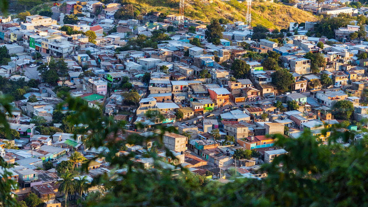 Picture of colourful houses surrounded by nature.