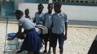 Students at a secondary school in southeast Haiti wash their hands after an awareness-raising session organized by HI's local partner, RANIPH (Réseau Associatif National pour l’Intégration des Personnes Handicapées).