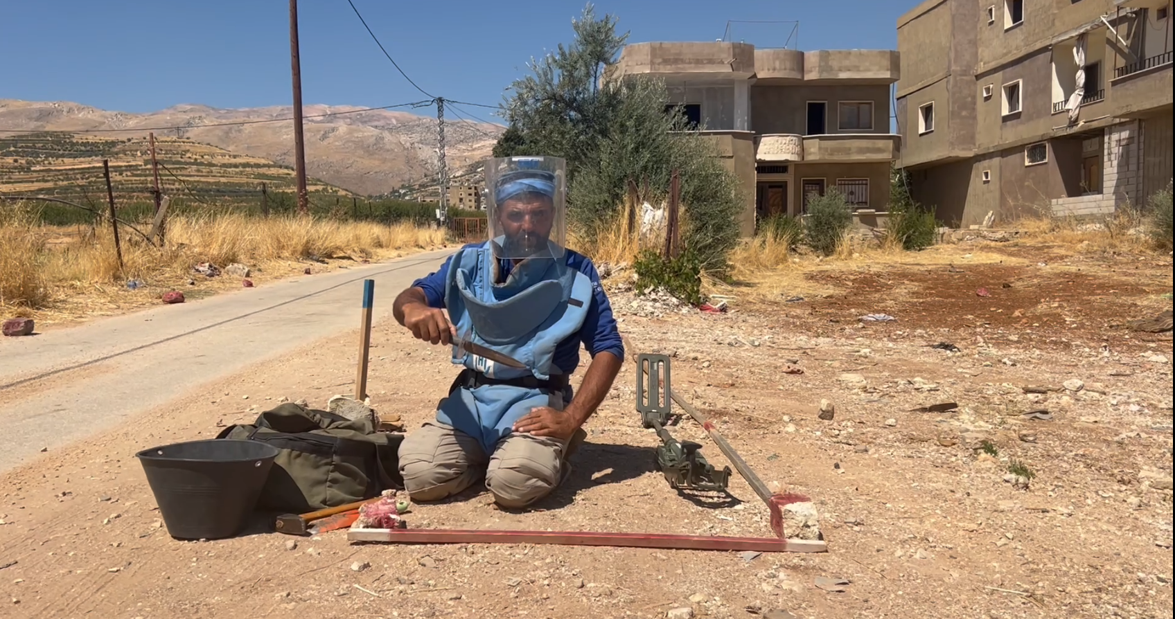 A HI deminer checking his equipment