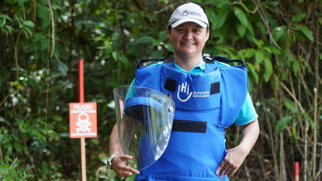 Marta Quintero smiling in her Humanity & Inclusion demining gear in the Chaparral region of Colombia