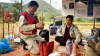 Daovy (left) at the clearance base during resting time in the village of Sophoun with a member of the administrative team, Laos. October 2023. 