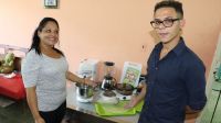 Fabián and his mother stand in front of their confectionery kit donated by HI in Santiago de Cuba.