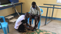 Hakim during the fitting of his 3D printed orthosis in Omugo settlement, Uganda