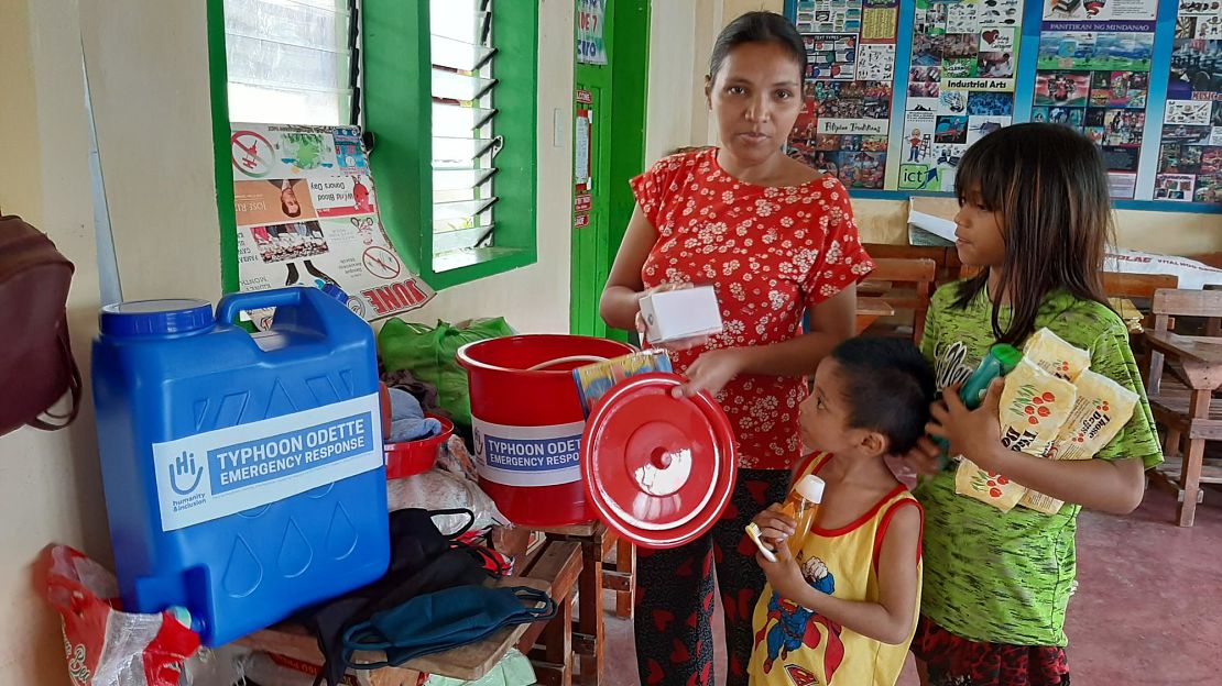 Mary Joy Maling-on, 38, and her eight children receive a hygiene kit, including soap and toothbrushes.