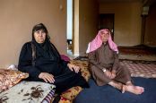 Hussein sitting on the floor of his home