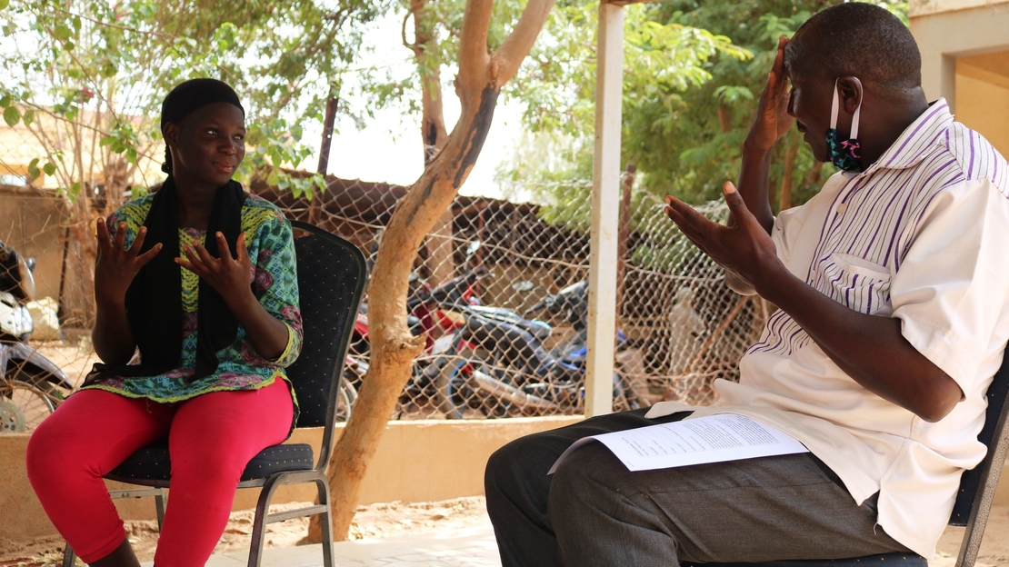 Sonia discussing with her former sign language teacher 