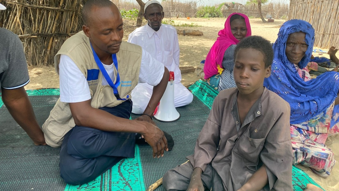 Mahamat with an HI agent in the displcaed people camp in Kousseri