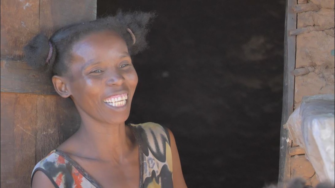 Woman smiling outside of her home