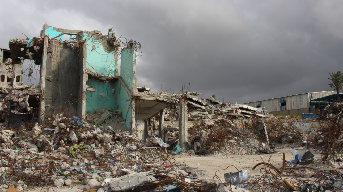 Destroyed buildings and rubble under a cloudy sky