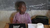 Souleymane Chapiou, 13, is studying in Maradi, Niger, with the help of adapted teaching materials provided by HI.