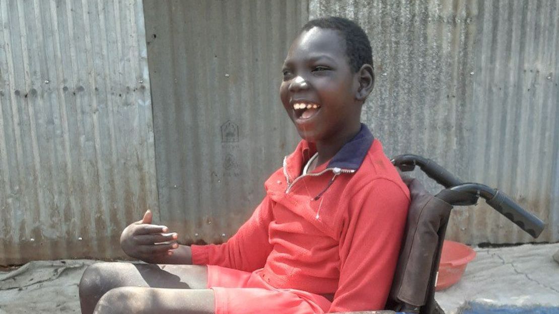 Omod smiles in his new wheelchair.