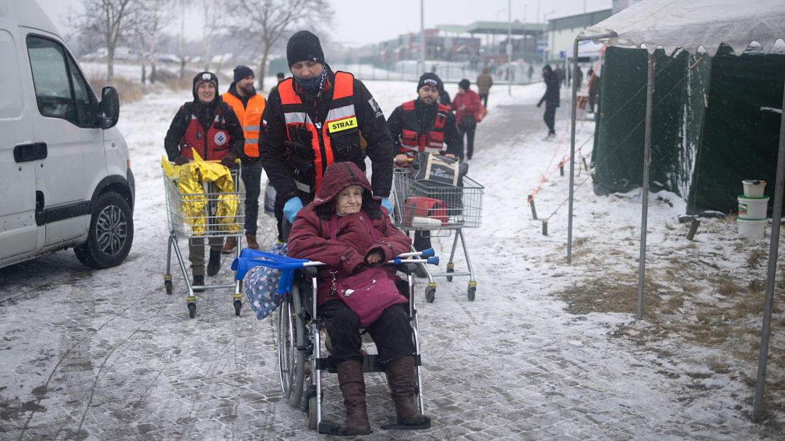 87-year old Galaina is assisted as she flees conflict in Ukraine at the Polish border