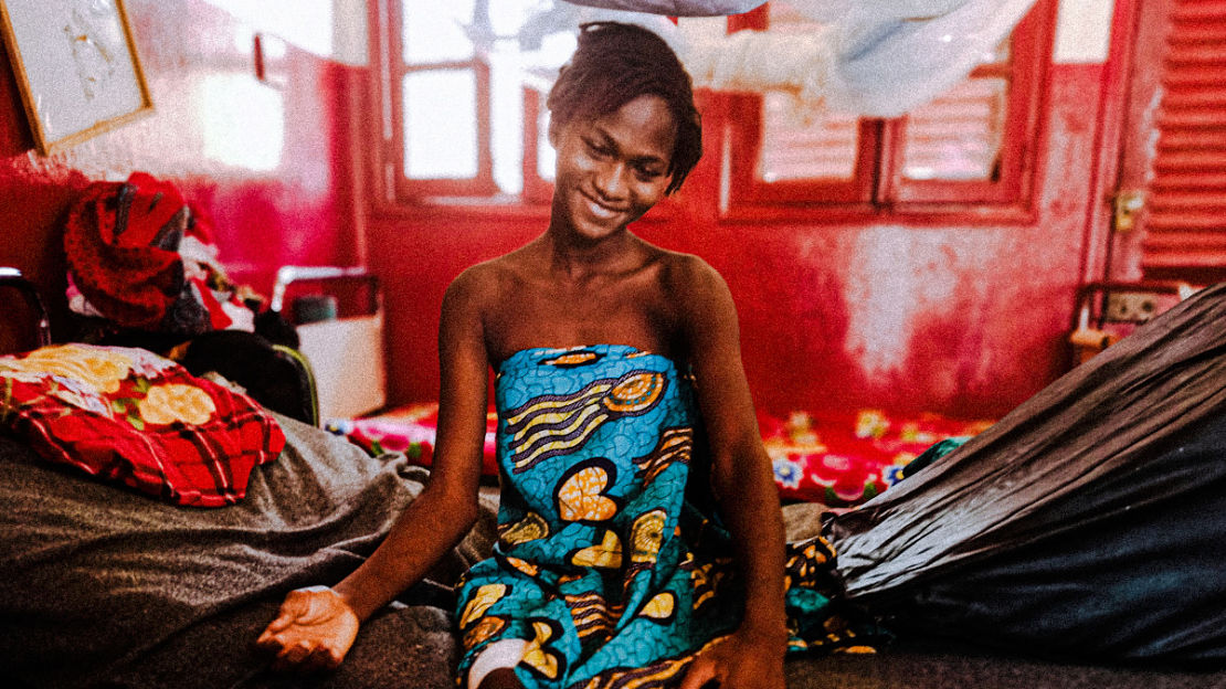 Alima sits in her bed at the Bambari hospital following an accident with an explosive device (2021). 