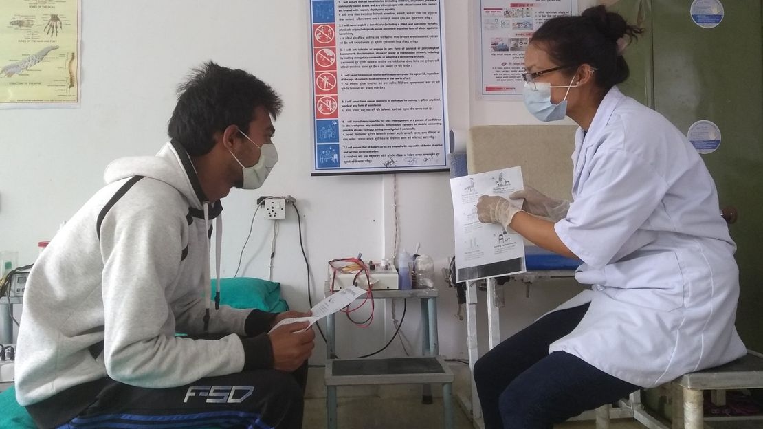 Rajina, an HI physio, provides instructions to beneficiaries with different exercises at rehabilitation unit in Nepal (June 2020)