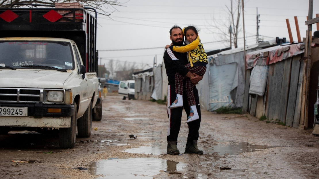 Adnan Al Hussein and his daughter Nada in an informal camp in Lebanon after fleeing Idlib, Syria in 2013.