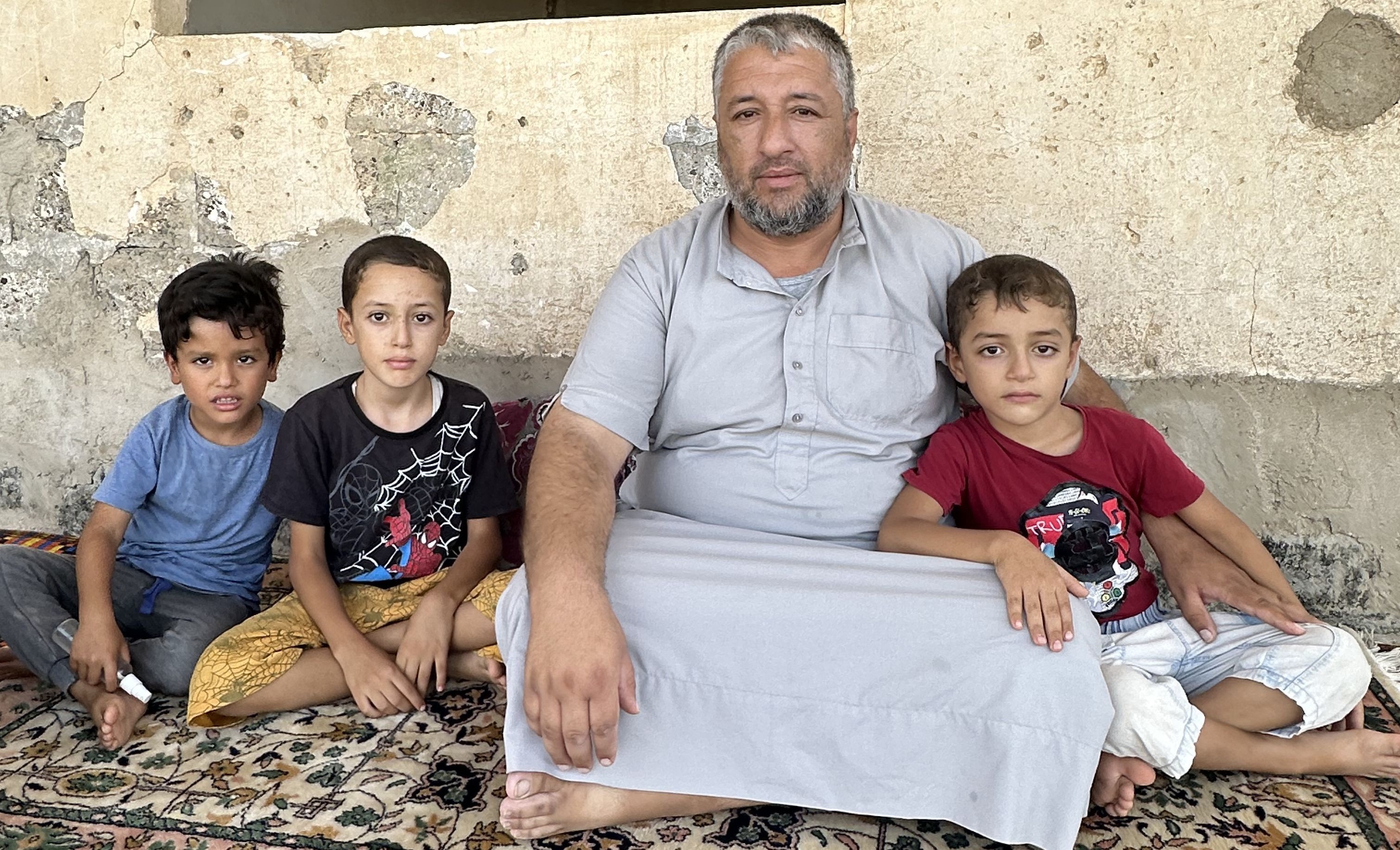 Qais at his home with his chidren 