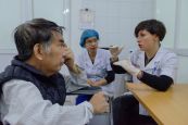 HI speech therapist Stephanie Wells discusses a patient progress with Dr. Duc Nguygen during a speech therapy session at Bach Mai National Hospital