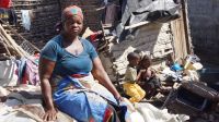 Lucia in front of the remains of her home, destroyed by Cyclone Idai, Beira, Mozambique