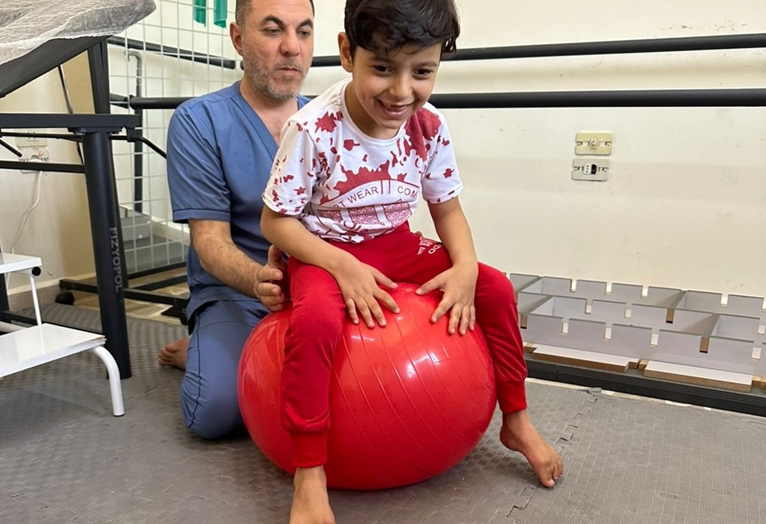 HI physical therapist Qasim Al Ahmad with Hadi. 