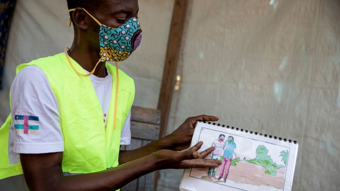 An outreach officer uses an awareness image box on Covid-19 in Bangui, Central African Republic, November 19, 2020. As part of the activities of the Synergies project, people with disabilities have been informed about the virus and preventative measures by their peers through the network of organizations of people with disabilities (DPOs).