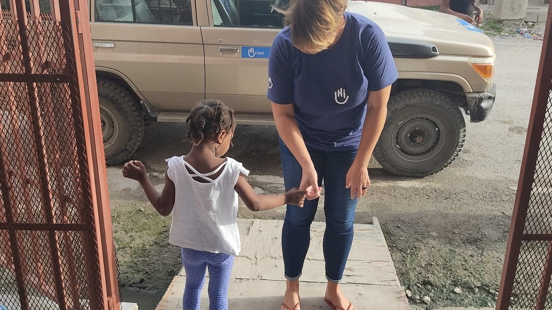 HI staff with a child being supported  at the rehabilitation center in Les Cayes, Haiti after the earthquake. 2021