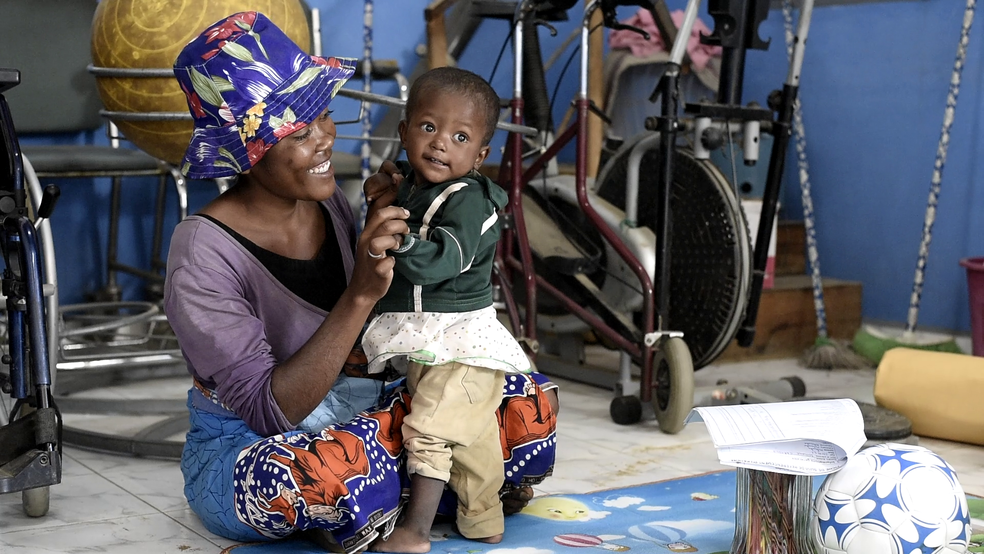 Sosiany and her mother Naliny play together before her stimulation therapy session.