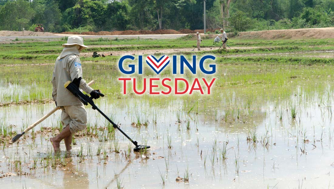 An HI deminer using a metal detector in a paddy field, Laos