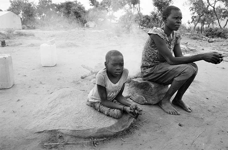 Beatrice sitting with her mum Reida in Omugo refugee camp.