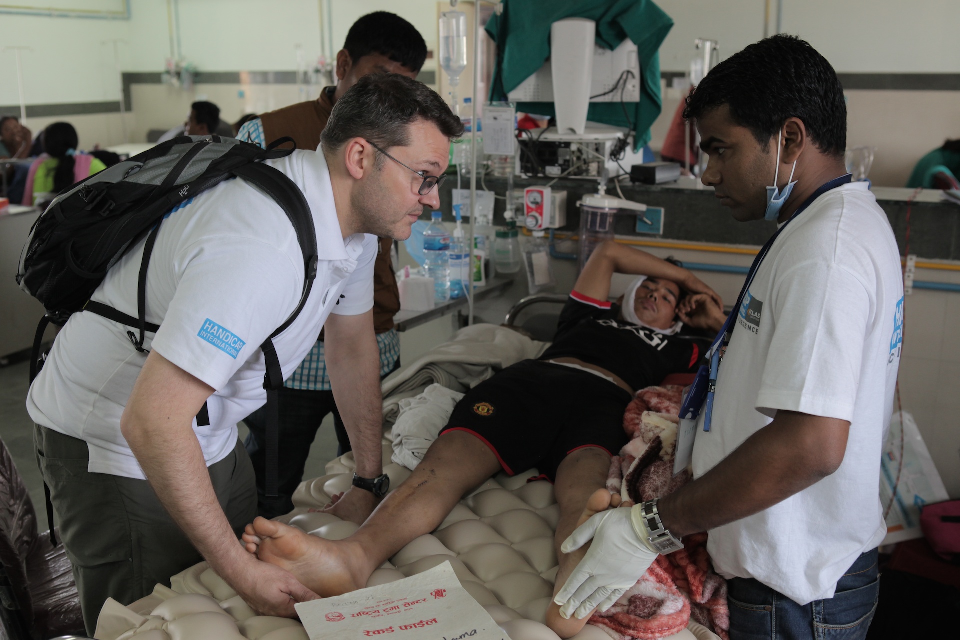 HI physical therapists attend to a victim of the Nepal earthquake with a spinal cord and a head injury.