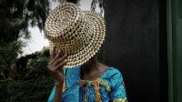 A woman with her face hidden by a hat.