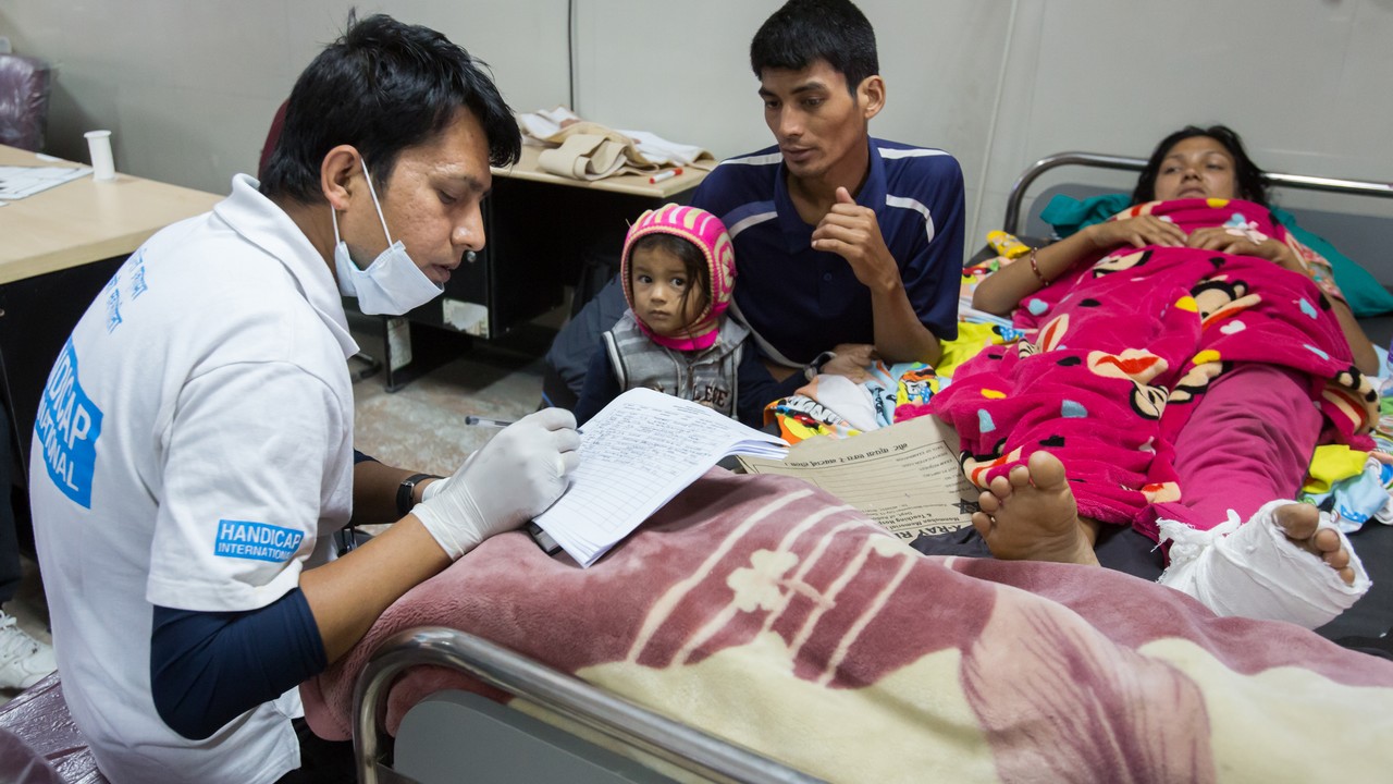 Occupational therapist, Pushpak, assesses the needs of an injured earthquake victim. Nepal.