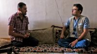 Shwan, a member of Handicap International’s team, listens to Abdelillah during a psychosocial support session. 