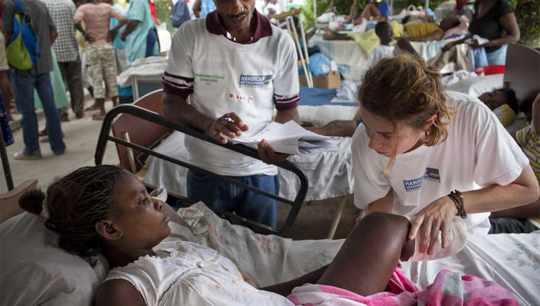 An HI physical therapist provides emergency rehabilitation treatment to a victim of the earthquake in 2010