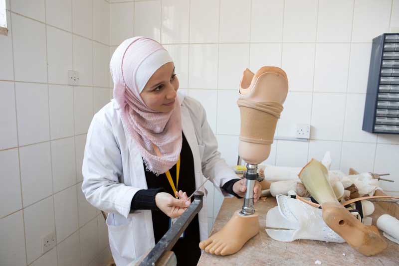 A technician adjusts a prosthesis a Basma Hospital, Jordan
