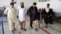 A physical therapist from Kandahar Physical Rehabilitation Centre guiding the amputees during gait training process.