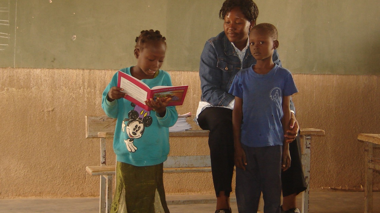 Estelle Koudougou, Handicap International's Inclusive Education project manager in Burkina Faso with two children.