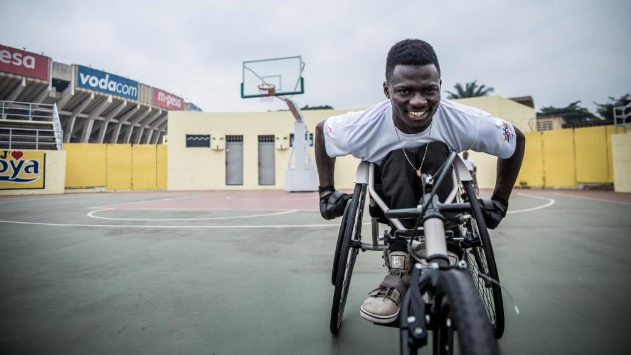 John, an athlete from the DR Congo Paralympic team, warms up before a demonstration of the new racing wheelchairs.