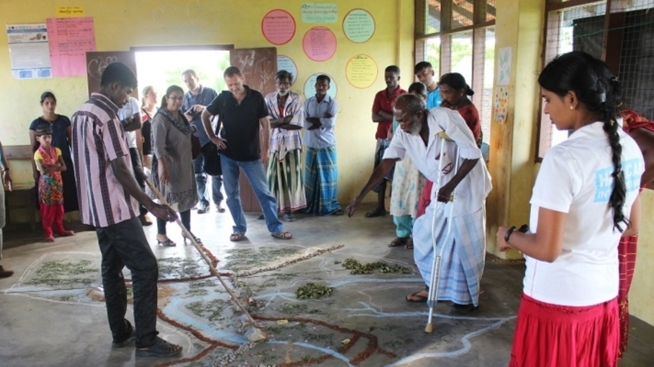 Villages in the Batticaloa region of Sri Lanka meet to draw up an emergency evacuation plan. They have drawn a map of the village on the ground. 