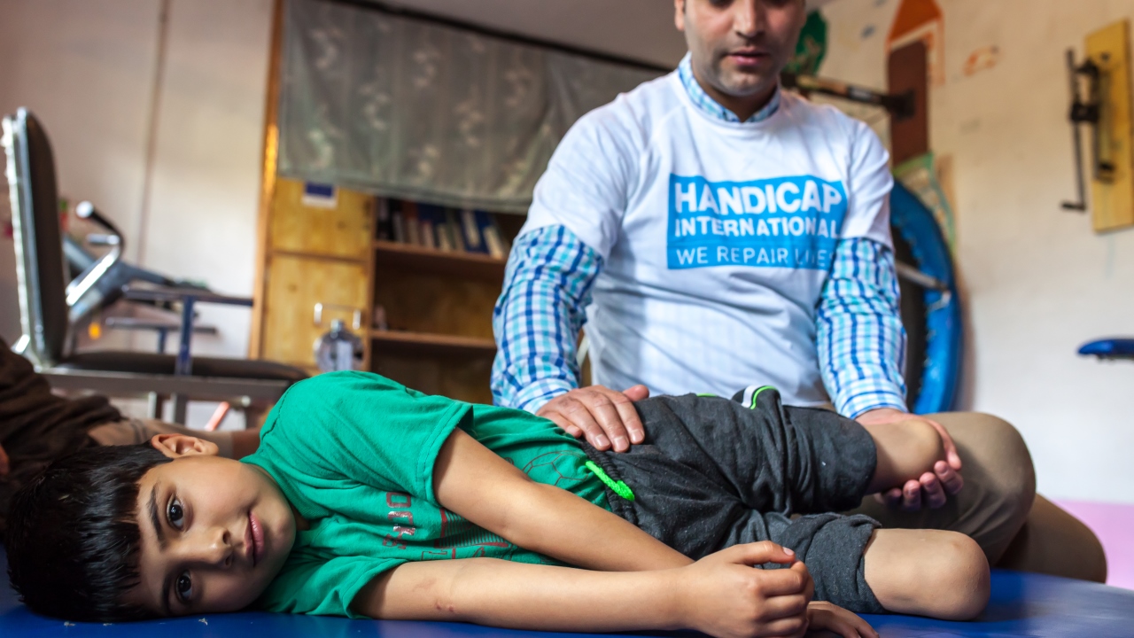 Fayaz during a rehabilitation session with Muddasir Ashraf, a physical therapist and Disability Manager for Handicap International
