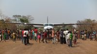 Inhabitants of Sibut greet the first airplane to land on the airstrip since its rehabilitation.
