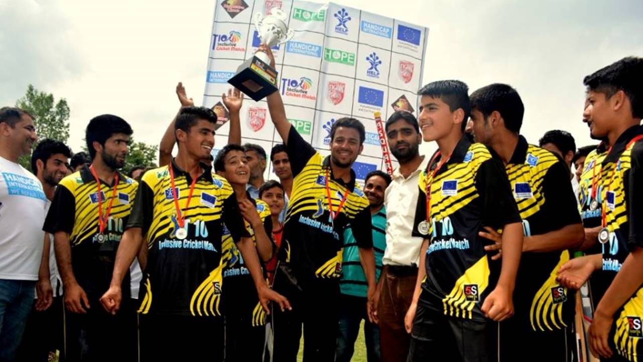 The Kupwara Tigers lift the trophy after an inclusive cricket match organized by Handicap International